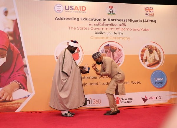 USAID Education Program Manager Olawale Samuel (right) receives an award for his work on the Addressing Education in Northeast Nigeria activity from His Royal Highness Alhaji Mai Abubakar Umar Suleiman, the Emir of Bade, Yobe State (right).